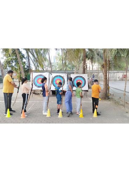 Students line up for their turn to shoot at the targets. We maintain a structured environment to ensure everyone gets ample practice.