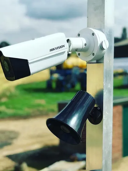A Hikvision camera paired with an audio horn for an active deterrence system. This setup can play automated warnings or allow you to speak directly to anyone on your property.