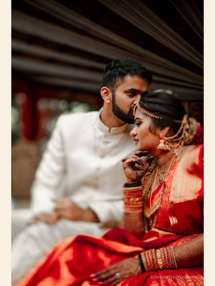 A tender moment between the bride and groom. The groom's forehead kiss and the bride's serene expression create a beautiful, intimate portrait.