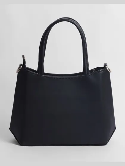 A clean shot of the back of a black women's handbag. We provide a complete set of images for every product.