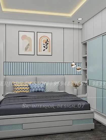 A bedroom featuring a sliding wardrobe and a bed with built-in storage drawers. The headboard wall has a light blue fluted panel, adding texture and a pop of color.
