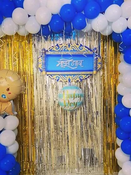 A closer view of the naming ceremony backdrop with a custom Marathi nameplate for "Madhav".