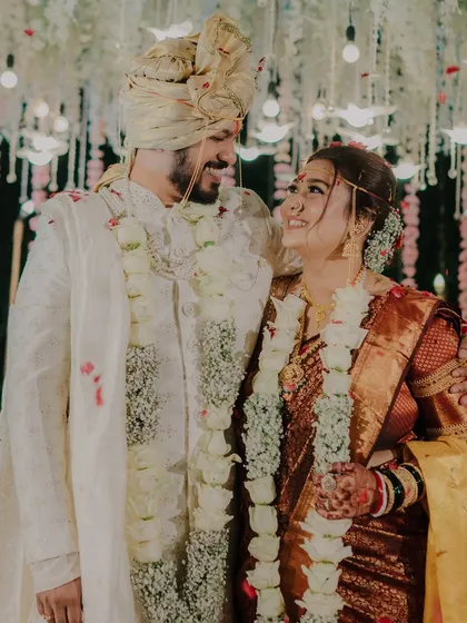 Looking at each other with love and admiration under the beautifully decorated mandap. A perfect capture of post-ceremony bliss.