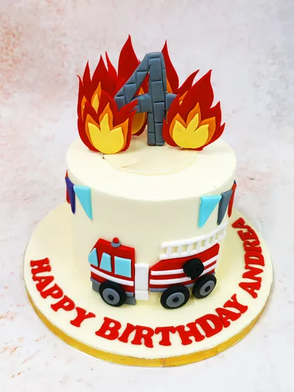 This Firetruck Cake is ablaze with excitement, featuring edible flames, a number '4' topper, and a fire engine on the side.