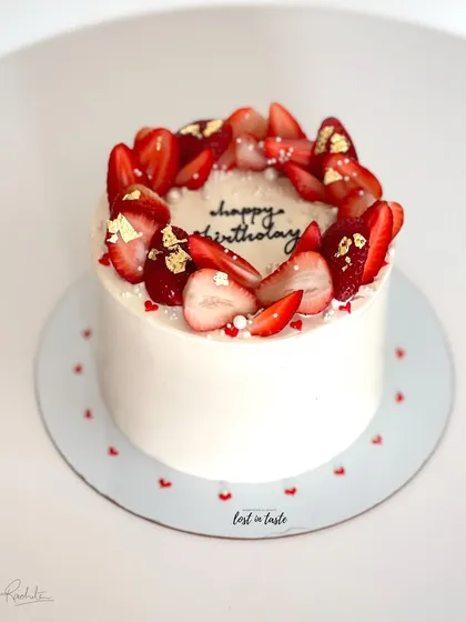 A seasonal favorite, this Vanilla Strawberry cake is topped with fresh strawberries, edible gold leaf, and tiny sugar pearls. It's available as a celebration cake or a smaller bento cake.