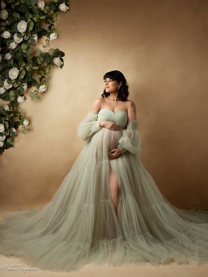 A dreamy, ethereal portrait in a soft green tulle gown. This is for the mamas who want to feel like a fairy-tale princess.