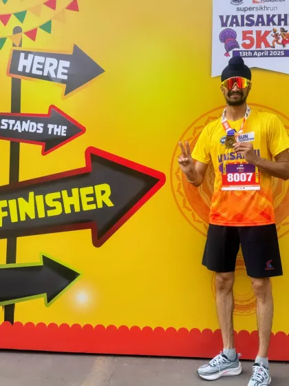 Posing at the finisher's wall after completing the Vaisakhi 5K run with a personal best time. Setting and achieving goals is what drives me forward.
