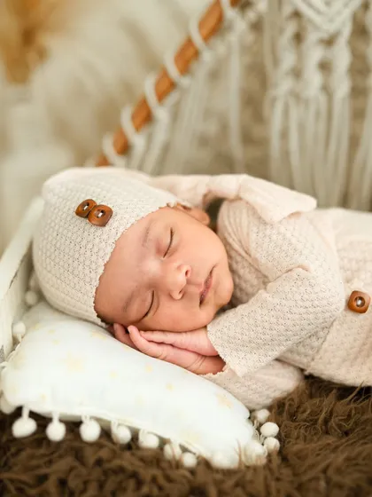 A close-up from a newborn session, highlighting the peaceful and delicate features of a baby in their first few weeks. We ensure a safe and warm environment, using gentle posing and soft textures to capture these fleeting moments.