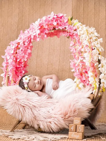A 45-day-old baby girl sleeping in a beautiful floral hoop. Even as they get a little older, we can still capture these peaceful, angelic moments.
