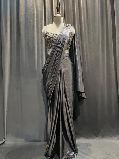 This metallic grey drape saree combines Indian tradition with a bold, modern twist. The liquid-like fabric drapes beautifully for a contemporary look.