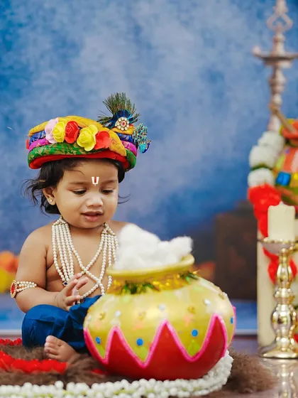 Our little Krishna is caught in the act, looking thoughtfully at a pot of 'makhan' (butter) in this classic and mischievous pose.