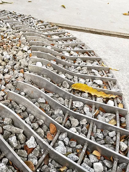 A detail of the water drainage system at the Museum of Art and Photography (MAP) in Bangalore. The custom-designed aluminum grates filled with gravel are a small but important part of the building's infrastructure, showing our attention to both function and aesthetics.
