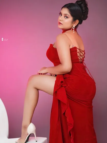For a bold and glamorous look, I designed this vibrant red gown. It features a modern silhouette with a high slit and a stylish halter neck, making it a perfect choice for cocktail parties or evening events.