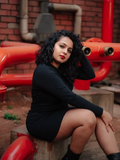 A duplicate of image 262, this portrait uses the contrast of a black dress against red pipes for a striking industrial fashion shot.