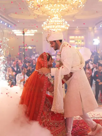 The perfect Varmala moment, complete with dramatic cold pyrotechnics and a shower of petals. I orchestrate these key moments to be as spectacular and memorable as the love they represent.