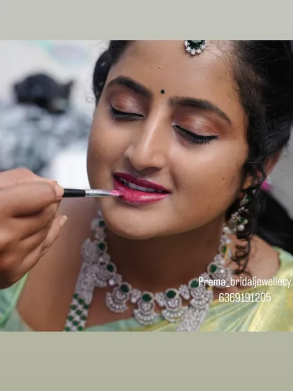 The final touch. Applying the perfect lip shade is one of the last steps to bring the whole look together. This behind-the-scenes moment shows the care I take in perfecting every detail for my clients.