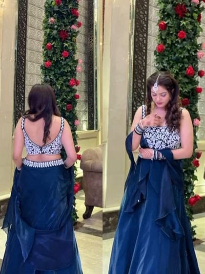 This client chose a stylish dark blue lehenga with a heavily embroidered silver blouse. The ruffled dupatta adds a modern touch to this beautiful rental outfit.