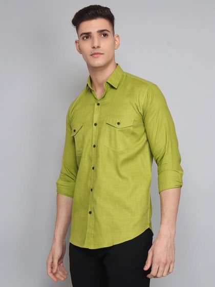 A three-quarter shot of a model in a lime green casual shirt against a simple grey wall, perfect for catalogue and website use.