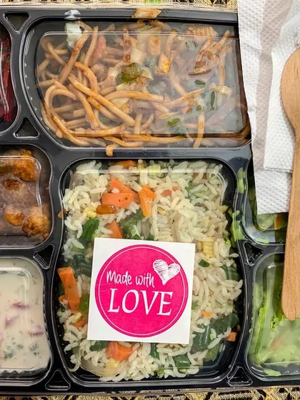 Every meal is packed with love. A close up of one of my meal trays, complete with a wooden spoon and napkin, ready to be enjoyed.