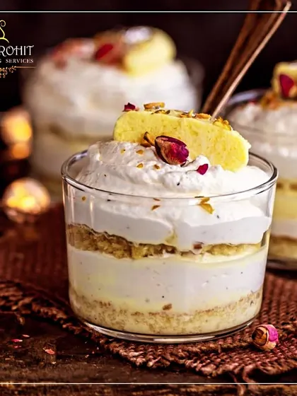 A close-up of my fusion dessert, Rasmalai Tres Leches. This dessert combines the flavors of Indian rasmalai with the texture of a creamy Latin American tres leches cake, garnished with rose petals.