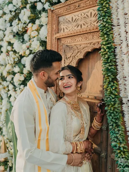 An intimate portrait of the couple during their South Indian Haldi, showcasing their beautiful traditional outfits and the genuine happiness they share.