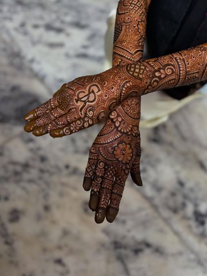 A crossed-hands pose showing the personalized initial.