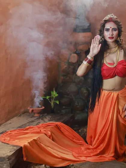 A powerful pose with the 'abhaya mudra' hand gesture. The smoke effect adds a layer of mystery and divinity to this conceptual Durga-themed portrait.