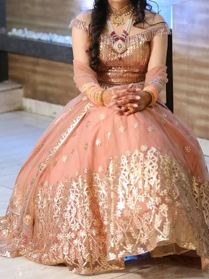For an engagement or reception, you can rent a statement jewellery set like this one. The client is wearing a layered necklace with an off-shoulder lehenga, creating a modern yet traditional style. This shows how versatile my rental collection is for different wedding events.