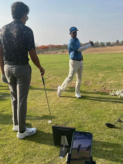 A coach uses a launch monitor and video feedback to help a player understand their swing dynamics. This combination of data and visual feedback accelerates learning and improvement.