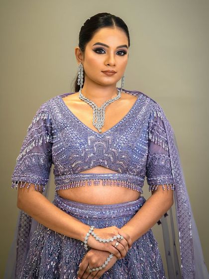A front view of the lavender lehenga, focusing on the stunning diamond necklace that complements the outfit perfectly.