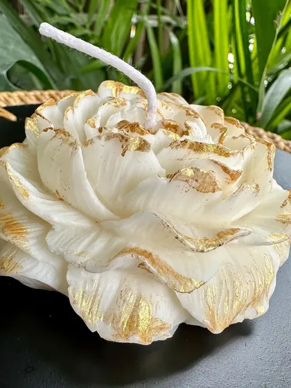 A close-up of my hand-painted peony candle. I use gold paint to highlight the edges of the petals, adding a touch of luxury. These are available scented or unscented.