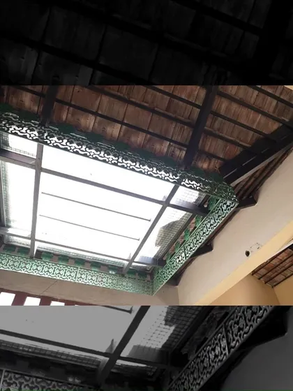 Duplicate of 155. The skylight in the Padmaja Rao Residence is framed with ornate green metalwork, adding a decorative flourish to this functional element and enhancing the traditional aesthetic.