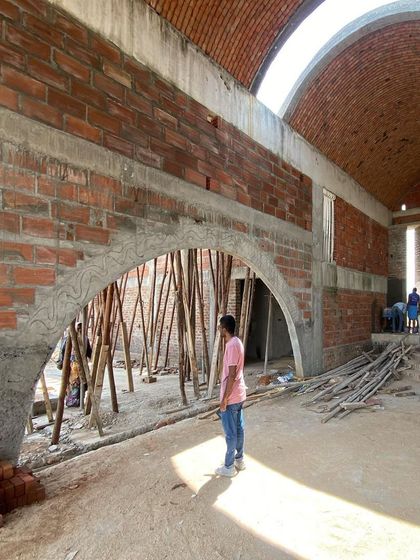 The interior of a project featuring vaulted brick ceilings and arched openings. This technique, known as timbrel vaulting, is both sustainable and structurally beautiful, creating expansive, light-filled spaces.