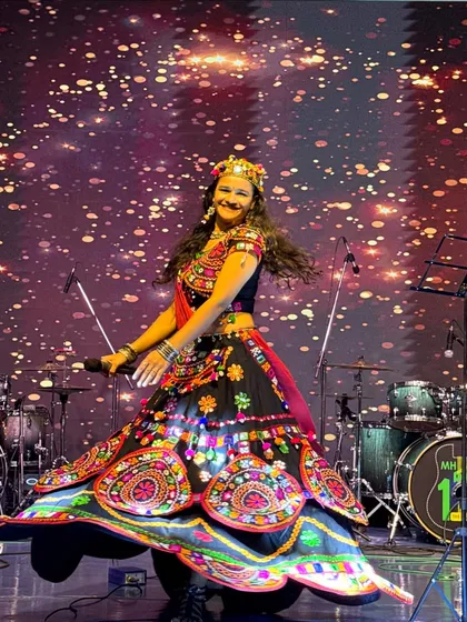 On stage, I come alive. This shot from a Navratri event captures the dynamic movement and vibrant energy I bring, modeling a stunning traditional ghagra choli.