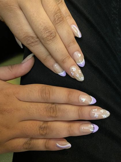 A delicate and pretty design with lavender French tips and tiny, hand-painted white butterflies on a sheer base.