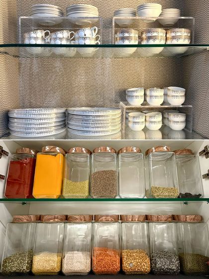 A cabinet that combines pantry and crockery storage. The top section holds plates and bowls, while the bottom is for decanted spices and grains, creating a complete kitchen station.