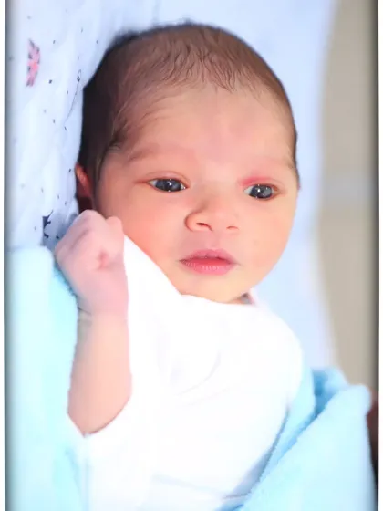 An awake and curious newborn looking into the camera. I love capturing their beautiful, expressive eyes in these early days.