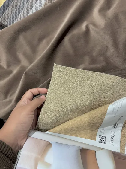 Selecting the perfect fabrics for a project. We carefully curate every material to create a cohesive and inviting space.