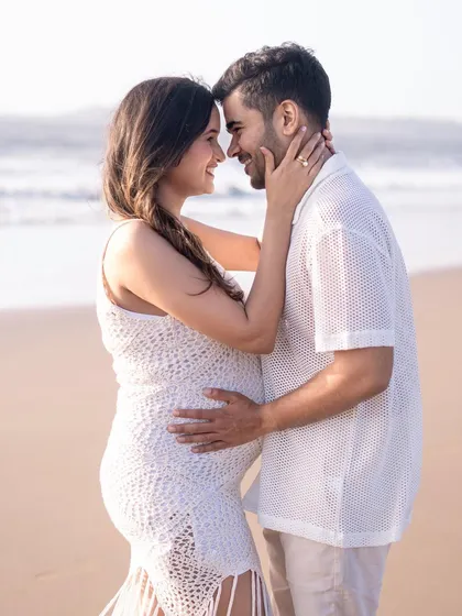 An intimate portrait of an expecting couple on the beach at golden hour. The soft light and natural setting create a timeless and romantic memory of their journey to parenthood.