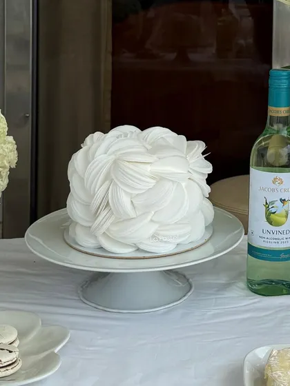 A close-up of the intricate, layered wafer paper petals on this unique white bloom cake.