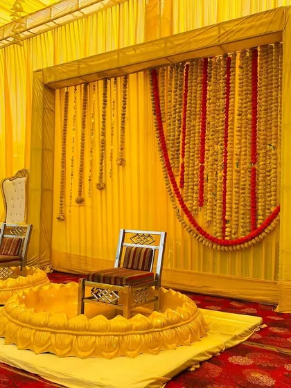 Another angle of the traditional Haldi setup, showing the elegant high-back chairs for other family members.