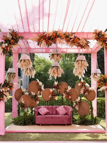 This Mehendi stage proves that you don't have to stick to traditional colors. I used a palette of pinks, oranges, and rustic browns with pampas grass and woven backdrops to create a chic, contemporary, and feminine vibe.