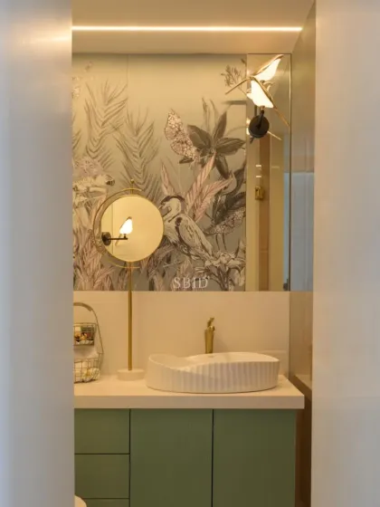 A close-up of the daughter's bathroom, highlighting the whimsical bird-themed wallpaper and matching bird light fixture over the vanity.