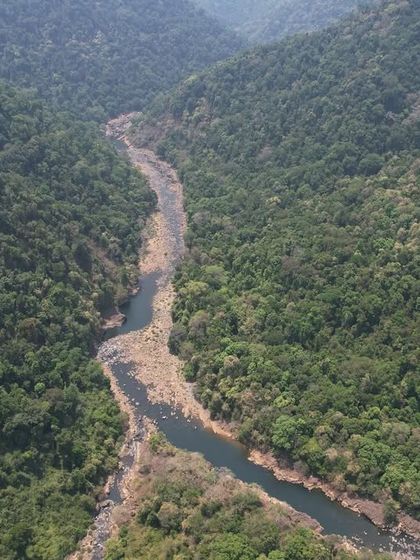 An aerial view of the Aghanashini river winding its way through the dense forest of the Western Ghats.