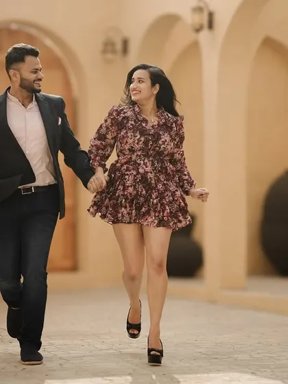 A candid moment captured as the couple enjoys a walk through our Santorini-inspired set. This shows the versatility of my studio, offering diverse architectural styles for your photoshoot all in one location.