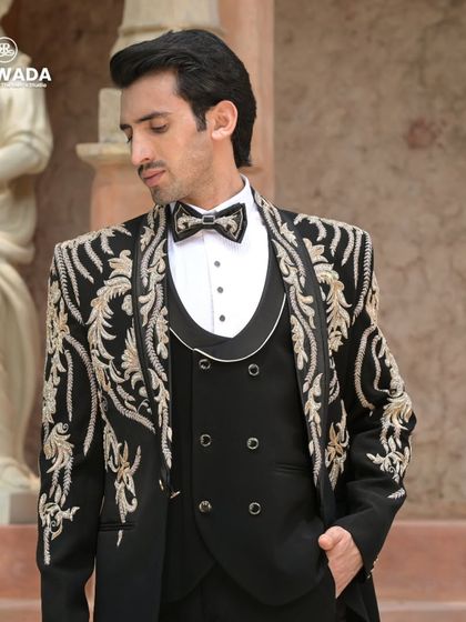 A closer portrait in the baroque tuxedo, highlighting the detailed craftsmanship around the lapels and shoulders.