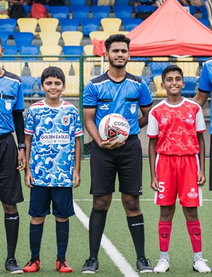 The team captains with the referees before a Thane Youth League match. We teach our players about sportsmanship and the official rules of the game.