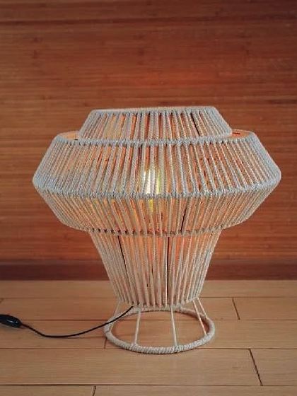 This large, stylish macrame table lamp is perfect for making a statement. The wrapped cord design is modern yet rustic, and it gives off a beautiful, warm glow.