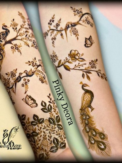 A delicate and artistic design featuring peacocks, birds, and butterflies on branches, creating a beautiful nature-inspired scene on the arms.