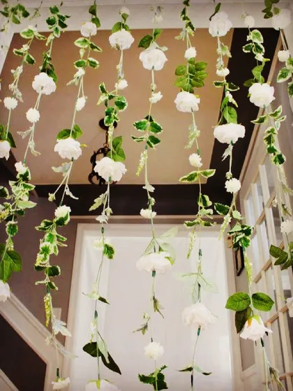 To add a touch of elegance to this doorway, we created a delicate curtain of hanging artificial flowers and leaves. This is a creative way to frame a view or transition between spaces.